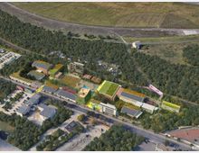 Luftaufnahme einer urbanen Parklandschaft mit Gebäuden, die überwiegend Gründächer und Photovoltaikanlagen haben, eingebettet in eine bewaldete Umgebung. Im Hintergrund befinden sich Felder und eine Bahnstrecke, während im Vordergrund Straßen und Parkplätze sichtbar sind.