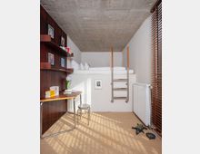 Small loft-style bedroom with a raised platform bed under a raw concrete ceiling, accessed by a metal ladder. A built-in dark wood wall unit with desk and shelves lines one side, and a large window with wooden blinds and a radiator brings in striped sunlight across the carpeted floor.