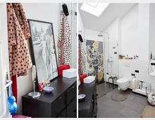 Modernes Badezimmer mit weißen Wänden und schwarzem Mobiliar, einschließlich einer schwarzen Kommode mit Kosmetikartikeln und dekorativen Elementen. Im Raum befinden sich eine ebenerdige Dusche mit auffälligem Wanddesign, eine weiße Toilette, ein Waschbecken sowie ein Dachfenster, das Tageslicht hereinlässt.