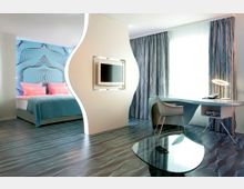 Modernes Hotelzimmer mit geschwungener Trennwand, die den Schlafbereich mit einem Doppelbett vom Arbeitsbereich mit Schreibtisch und Stuhl abgrenzt. Der Raum ist in hellen Farben gestaltet, mit einer großen Fensterfront, einer gemusterten Wandtapete und einem Glas-Couchtisch.